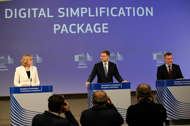 (LtoR) EU Executive Vice-President for Tech Sovereignty, Security and Democracy Henna Virkkunen, EU Commissioner for Economy and Productivity, Implementation and Simplification Valdis Dombrovskis, and EU Commissioner for Democracy, Justice, the Rule of Law and Consumer Protection Michael McGrath give a press confrence to present the digital simplification package at the EU headquarters in Brussels on November 19, 2025. With this digital omnibus, the Commission is proposing to simplify existing rules on Artificial Intelligence, cybersecurity, and data. (Photo by Nicolas TUCAT / AFP)