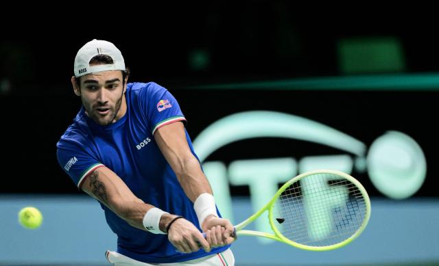 Italy's Matteo Berretini plays a backhand return to Austria's Jurij Rodionov during their Davis Cup men's singles quarter finals tennis match, at the Super Tennis Arena, in Bologna, northen Italy, on November 19, 2025. (Photo by Tiziana FABI / AFP)