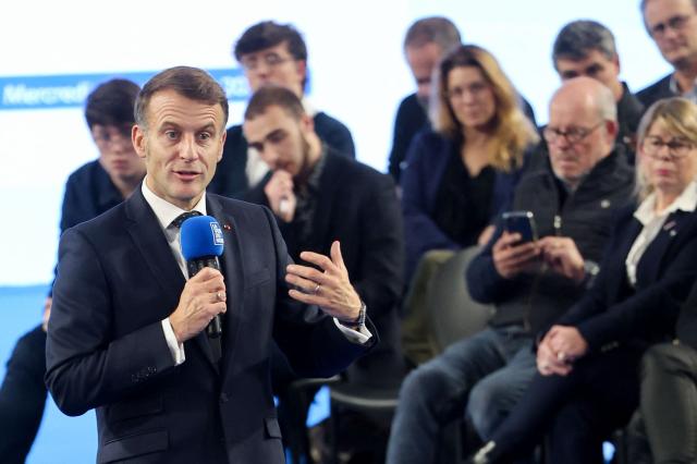 France's President Emmanuel Macron (C) addresses the audience during a meeting with some readers of the daily newspaper "La Voix du Nord" in Arras, northern France, on November 19, 2025. (Photo by Francois LO PRESTI / POOL / AFP)