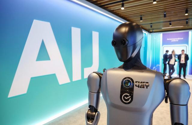In this pool photograph distributed by the Russian state agency Sputnik, Russia's anthropomorphic AI-equipped robot developed by technology company Sber is pictured at an exhibition of the AI Journey international AI (Artificial intelligence) conference in Moscow on November 19, 2025. (Photo by Vyacheslav PROKOFYEV / POOL / AFP)