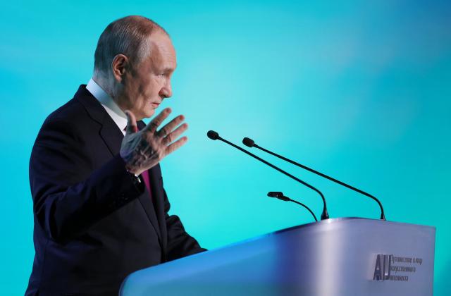 In this pool photograph distributed by the Russian state agency Sputnik, Russia's President Vladimir Putin gives a speech during the AI Journey international AI (Artificial intelligence) conference in Moscow on November 19, 2025. (Photo by Vyacheslav PROKOFYEV / POOL / AFP)