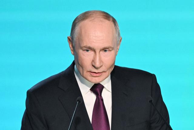 In this pool photograph distributed by the Russian state agency Sputnik, Russia's President Vladimir Putin gives a speech during the AI Journey international AI (Artificial intelligence) conference in Moscow on November 19, 2025. (Photo by Kristina Kormilitsyna / POOL / AFP)