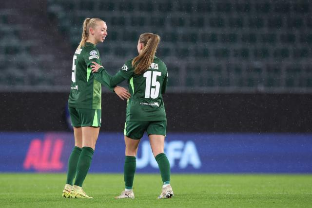 VfL Wolfsburg's Dutch midfielder #05 Ella Peddemors (L) celebrates with VfL Wolfsburg's Dutch defender #15 Janou Levels after scoring the 2-1 goal during the UEFA Women's Champions League day 4 football match VfL Wolfsburg vs Manchester United in Wolfsburg, Germany, on November 19, 2025. (Photo by Ronny HARTMANN / AFP)