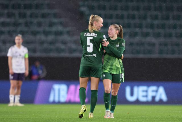 VfL Wolfsburg's Dutch midfielder #05 Ella Peddemors (L) celebrates with VfL Wolfsburg's Dutch defender #15 Janou Levels after scoring the 2-1 goal during the UEFA Women's Champions League day 4 football match VfL Wolfsburg vs Manchester United in Wolfsburg, Germany, on November 19, 2025. (Photo by Ronny HARTMANN / AFP)