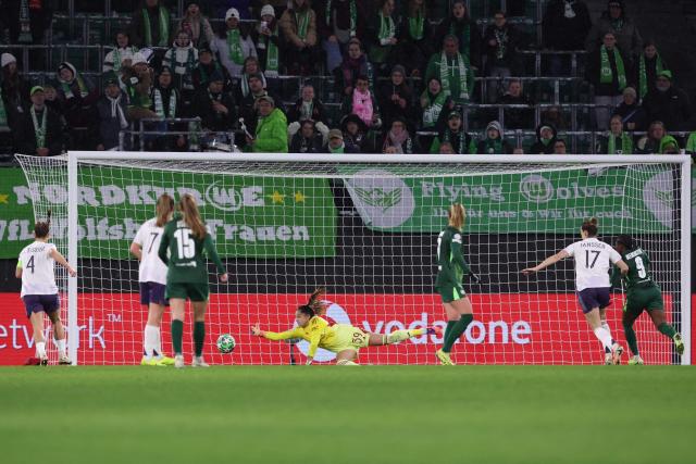 VfL Wolfsburg's Dutch midfielder #05 Ella Peddemors (not pictured) scores the 2-1 goal past Manchester United's Welsh goalkeeper #39 Safia Middleton-Patel (C) during the UEFA Women's Champions League day 4 football match VfL Wolfsburg vs Manchester United in Wolfsburg, Germany, on November 19, 2025. (Photo by Ronny HARTMANN / AFP)