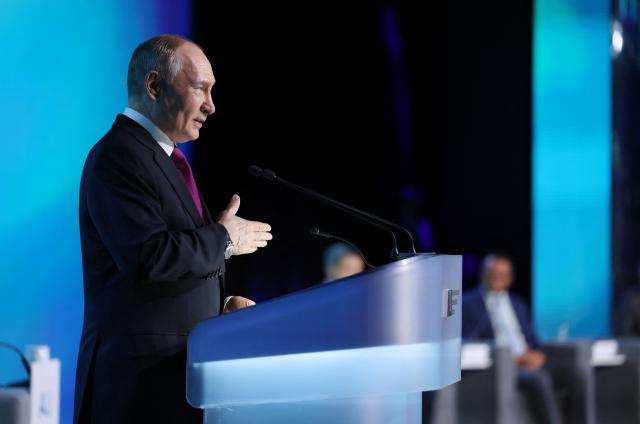 In this pool photograph distributed by the Russian state agency Sputnik, Russia's President Vladimir Putin gives a speech during the AI Journey international AI (Artificial intelligence) conference in Moscow on November 19, 2025. (Photo by Vyacheslav PROKOFYEV / POOL / AFP)