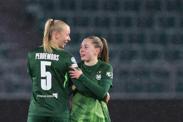 VfL Wolfsburg's Dutch midfielder #05 Ella Peddemors (L) celebrates with VfL Wolfsburg's Dutch defender #15 Janou Levels after scoring the 2-1 goal during the UEFA Women's Champions League day 4 football match VfL Wolfsburg vs Manchester United in Wolfsburg, Germany, on November 19, 2025. (Photo by Ronny HARTMANN / AFP)