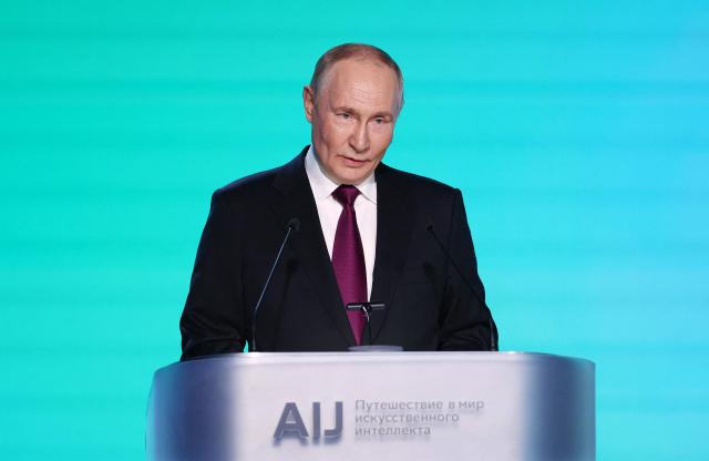 In this pool photograph distributed by the Russian state agency Sputnik, Russia's President Vladimir Putin gives a speech during the AI Journey international AI (Artificial intelligence) conference in Moscow on November 19, 2025. (Photo by Sergei Bulkin / POOL / AFP)