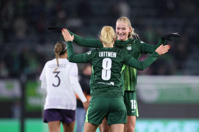 VfL Wolfsburg's German midfielder #08 Lena Lattwein (front) and VfL Wolfsburg's German defender #16 Camilla Kuver (R) celebrate the win after the end of the UEFA Women's Champions League day 4 football match VfL Wolfsburg vs Manchester United in Wolfsburg, Germany, on November 19, 2025. (Photo by Ronny HARTMANN / AFP)