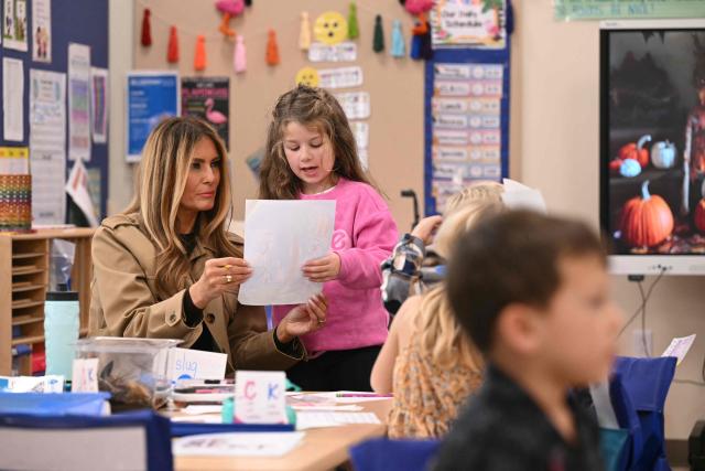 US First Lady Melania Trump speaks with a student at DeLalio Elementary School at Marine Corps Air Station New River in Jacksonville, North Carolina, November 19, 2025, as they travel to visit military families. (Photo by SAUL LOEB / AFP)