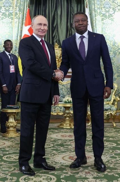 Russia's President Vladimir Putin and Togo's President of the Council of Ministers Faure Gnassingbe shake hands as they meet at the Kremlin in Moscow on November 19, 2025. (Photo by Ramil Sitdikov / POOL / AFP)