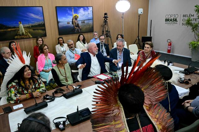 Brazil's President Luiz Inacio Lula da Silva (C), Indigenous Peoples Minister Sonia Guajajara (L), Environment Minister Marina Silva (2-L) and COP30 President Andre Correa do Lago (2-R) listen during a meeting with civil society members and Indigenous leaders at the COP30 UN Climate Change Conference in Belem, Para State, Brazil, on November 19, 2025. COP30 host Brazil pushed Tuesday for an early breakthrough at UN climate talks, with nations weighing a proposed deal that seeks to bridge major differences on fossil fuels, finance and trade barriers. Brazil wants an agreement reached by midweek, with President Luiz Inacio Lula da Silva to make an unexpected return on Wednesday to Belem, the host city in the country's Amazon region, in a high-level bid to seal a deal. (Photo by Pablo PORCIUNCULA / AFP)