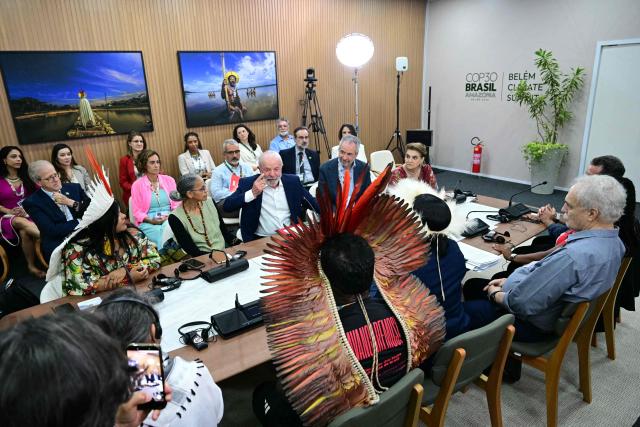 Brazil's President Luiz Inácio Lula da Silva (C) speaks during a meeting with civil society members and Indigenous leaders, alongside Indigenous Peoples Minister Sonia Guajajara (L), Environment Minister Marina Silva (2-L) and COP30 President Andre Correa do Lago (2-R), at the COP30 UN Climate Change Conference in Belem, Pare State, Brazil, on November 19, 2025. COP30 host Brazil pushed Tuesday for an early breakthrough at UN climate talks, with nations weighing a proposed deal that seeks to bridge major differences on fossil fuels, finance and trade barriers. Brazil wants an agreement reached by midweek, with President Luiz Inacio Lula da Silva to make an unexpected return on Wednesday to Belem, the host city in the country's Amazon region, in a high-level bid to seal a deal. (Photo by Pablo PORCIUNCULA / AFP)