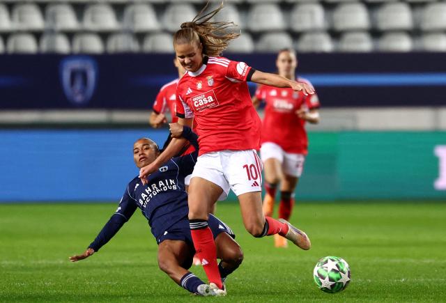 Benfica's Danish midfielder #10 Caroline Moller is tackled by Paris FC's forward #11 Sheika Scott during the UEFA Women's Champions League first round day 4 football match between Paris FC and SL Benficia at Stade Jean Bouin in Paris on November 19, 2025. (Photo by FRANCK FIFE / AFP)