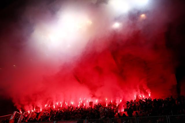 Benficia's supporters light smoke flares as they cheer on their team during the UEFA Women's Champions League first round day 4 football match between Paris FC and SL Benficia at the Stade Jean Bouin in Paris on November 19, 2025. (Photo by FRANCK FIFE / AFP)