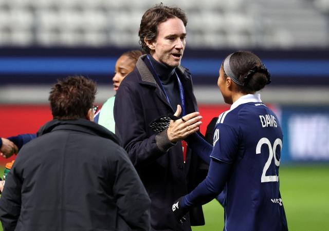 French representative of the Agache family holding company, Antoine Arnault (C) shakes hands with Paris FC's US defender #29 Deja Davis (R) at the end of the UEFA Women's Champions League first round day 4 football match between Paris FC and SL Benficia at the Stade Jean Bouin in Paris on November 19, 2025. (Photo by FRANCK FIFE / AFP)