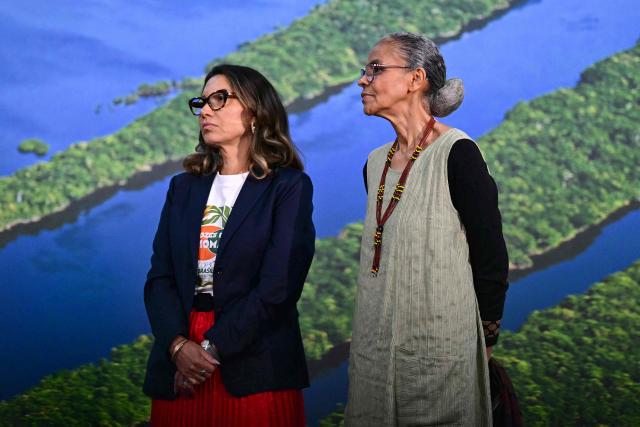 Brazil's First Lady Rosangela "Janja" da Silva (L) and Environment Minister Marina Silva look on as Brazil's President Luiz Inacio Lula da Silva (out of frame) speaks during a press conference at the COP30 UN Climate Change Conference in Belem, Para state, Brazil, on November 19, 2025. Brazilian President Luiz Inacio Lula da Silva hit the corridors of COP30 in Belem on Wednesday, in a push to land a deal at the UN climate talks as nations remained divided over contentious issues. (Photo by Pablo PORCIUNCULA / AFP)