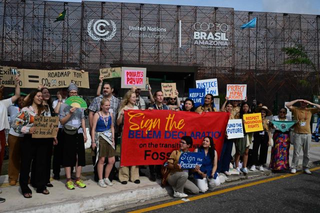 French climate activist Camille Etienne (L) and other activists take part in a demonstration during the COP30 UN Climate Change Conference outside the venue in Belem, Para state, Brazil on November 19, 2025. (Photo by Pablo PORCIUNCULA / AFP)