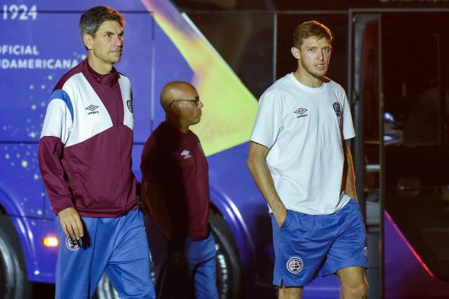 Lanus' head coach Mauricio Pellegrino (L) and midfielder Rodrigo Castillo arrive at the military base of the Silvio Pettirossi International Airport in Luque, Paraguay on November 19, 2025, ahead of the Copa Sudamericana final football match between Argentina's Lanus and Brazil's Atletico Mineiro in Asuncion on November 22. (Photo by DANIEL DUARTE / AFP)