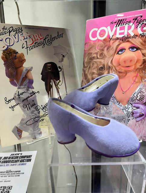 The Miss Piggy signed Cover Girl fantasy calendar 1981 is on display with a pair of her production-worn shoes for "Couldn't We Ride" bicycle scene of "The Great Muppet Caper" are displayed during a preview of the Jim Henson Company 70 years anniversary auction at Julien's Auctions warehouse in Gardena, California on November 19, 2025. Some of Jim Henson's most memorable creations go under the hammer in California next week, with the first US auction of puppets and memorabilia from his decades-long career.
Highlights include a pair of shoes worn by the domineering Miss Piggy in a "Muppets" movie, as well as puppets from "Fraggle Rock" and characters from the Netflix series "The Dark Crystal: Age of Resistance."
Fans will have the chance to bid on more than 400 items at the November 25 auctionx, which is also being held online on the Julien's Auctions website. (Photo by Paula RAMON / AFP)