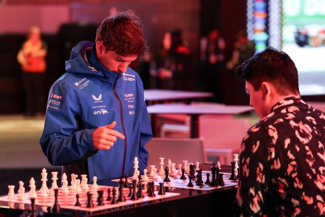 Alpine's French driver Pierre Gasly (L) plays chess in the paddock ahead of the Las Vegas Formula One Grand Prix in Las Vegas, Nevada, on November 19, 2025. (Photo by Patrick T. Fallon / AFP)