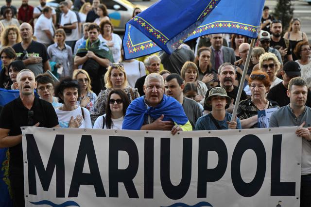 (FILES) Former residents of Mariupol, who were forced to leave their homes due to the Russian invasion take part in a meeting in central Kyiv on September 21, 2025, to mark the Day of the city of Mariupol, amid the Russian invasion of Ukraine. The Russian security agents were smirking. David was panicking. As the hours-long interrogation dragged on, he worried they would send him back to occupied Mariupol, and into the ranks of Russia's army. (Photo by Genya SAVILOV / AFP)