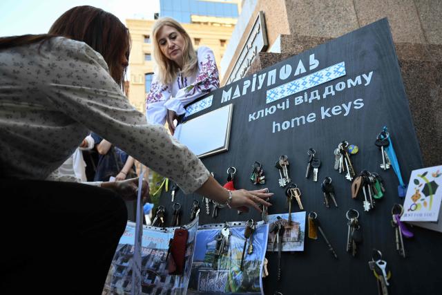 (FILES) Former residents of Mariupol, who were forced to leave their homes due to the Russian invasion leave keys of their abandoned apartments during a meeting in central Kyiv on September 21, 2025, to mark the Day of the city of Mariupol, amid the Russian invasion of Ukraine. The Russian security agents were smirking. David was panicking. As the hours-long interrogation dragged on, he worried they would send him back to occupied Mariupol, and into the ranks of Russia's army. (Photo by Genya SAVILOV / AFP)