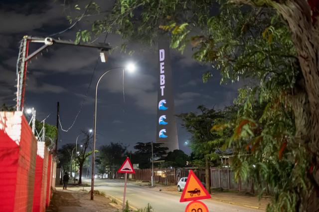 The Glasgow Actions Team project a message calling for debt justice onto the Sentech Tower in Johannesburg on November 19, 2025, ahead of the G20 leaders’ summit. (Photo by EMMANUEL CROSET / AFP)