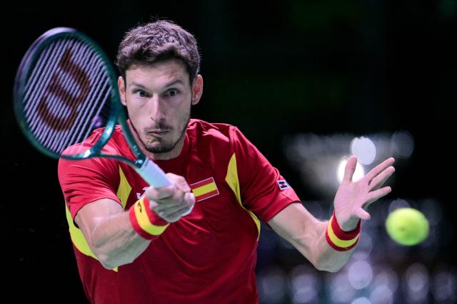 Spain's Pablo Carreno Busta plays a forehand return to Czech Republic's Jakub Mensik during their Davis Cup men's singles quarter finals tennis match, at the Super Tennis Arena, in Bologna, northen Italy, on November 20, 2025. (Photo by Tiziana FABI / AFP)
