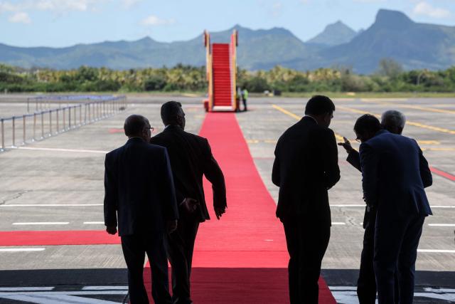 Officials prepare for the arrival of France's President Emmanuel Macron for his visit to Mauritius, at the Sir Seewoosagur Ramgoolam International Airport in Port Louis on November 20, 2025. (Photo by Ludovic MARIN / AFP)