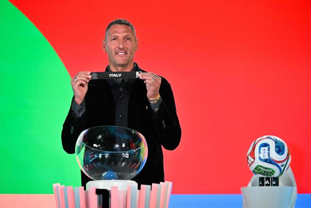 Italian former player Marco Materazzi shows the paper slip of Italy during the 2026 FIFA World Cup European Play-Off draw at the FIFA's Home of Football in Zurich on November 20, 2025. (Photo by Fabrice COFFRINI / AFP)