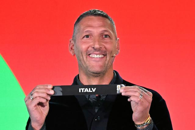 Italian former player Marco Materazzi shows the paper slip of Italy during the 2026 FIFA World Cup European Play-Off draw at the FIFA's Home of Football in Zurich on November 20, 2025. (Photo by Fabrice COFFRINI / AFP)