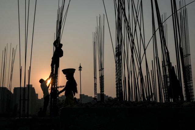TOPSHOT - Labourers work at the Mahatma Gandhi Ashram redevelopment site in Ahmedabad on November 20, 2025. (Photo by Shammi MEHRA / AFP)