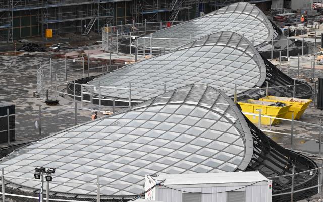 Skylights on the roof of the new underground main station of the railway development project Stuttgart 21 (S21) are pictured in Stuttgart, southern Germany, on November 20, 2025. The opening of a mammoth German rail project, which has become emblematic of the infrastructure woes plaguing Europe's biggest economy, has been delayed yet again, reports said November 19, 2025. "Stuttgart 21" is envisaged as a futuristic rail hub in the southwestern city, but its inauguration has been repeatedly pushed back from an original date of 2019. Trains were due to finally start running from the new underground station in December 2026, before a full opening in the summer of 2027. (Photo by THOMAS KIENZLE / AFP)