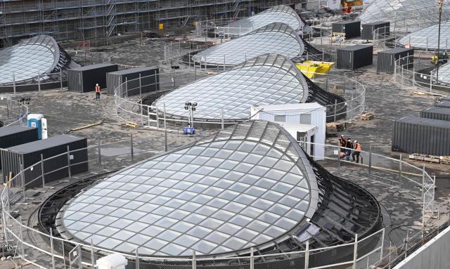 Skylights on the roof of the new underground main station of the railway development project Stuttgart 21 (S21) are pictured in Stuttgart, southern Germany, on November 20, 2025. The opening of a mammoth German rail project, which has become emblematic of the infrastructure woes plaguing Europe's biggest economy, has been delayed yet again, reports said November 19, 2025. "Stuttgart 21" is envisaged as a futuristic rail hub in the southwestern city, but its inauguration has been repeatedly pushed back from an original date of 2019. Trains were due to finally start running from the new underground station in December 2026, before a full opening in the summer of 2027. (Photo by THOMAS KIENZLE / AFP)