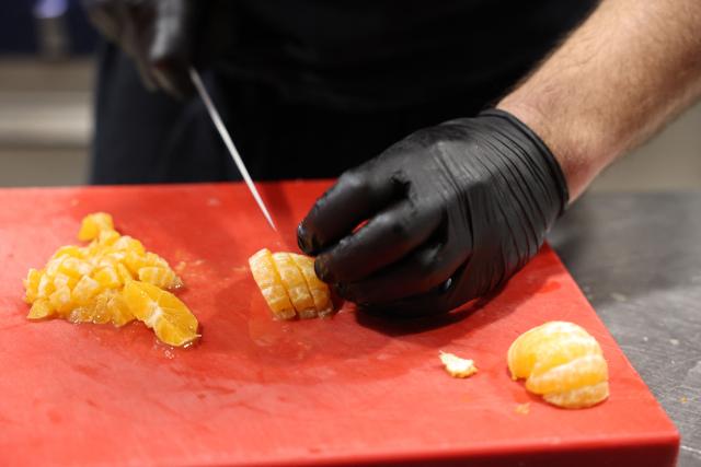 SanCarlo hotel restaurant's chef cooks Corsican clementines to prepare a dessert at the restaurant in Ajaccio, on the French Mediterranean island of Corsica, on November 15, 2025. (Photo by Pascal POCHARD-CASABIANCA / AFP)