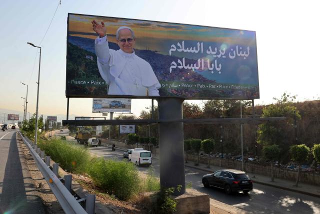 Cars go past a giant billboard of Pope Leo XIV on the highway that leads to Beirut's international airport on November 20, 2025. The Pope will travel to Turkey and Lebanon in a six-day trip beginning late November, his first since becoming head of the Catholic Church. (Photo by Anwar AMRO / AFP)