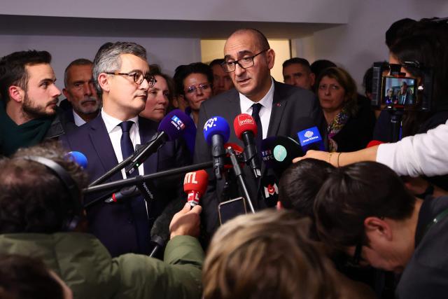 France's Interior Minister Laurent Nunez (C, R) and France's Justice Minister Gerald Darmanin answer journalists' questions during a visit following the killing last week in Marseille of the younger brother of anti-drug activist, in Marseille on November 20, 2025. The killing last week in Marseille of Mehdi Kessaci, the younger brother of anti-drug activist Amine Kessaci amplified concern over the soaring death toll of narcotics-driven crime. (Photo by CLEMENT MAHOUDEAU / AFP)