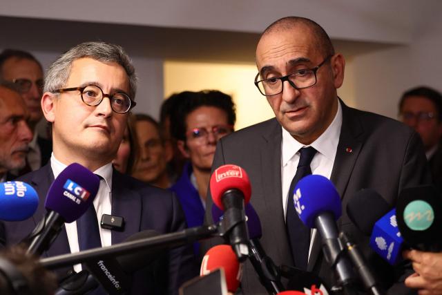 France's Interior Minister Laurent Nunez (C, R) and France's Justice Minister Gerald Darmanin answer journalists' questions during a visit following the killing last week in Marseille of the younger brother of anti-drug activist, in Marseille on November 20, 2025. The killing last week in Marseille of Mehdi Kessaci, the younger brother of anti-drug activist Amine Kessaci amplified concern over the soaring death toll of narcotics-driven crime. (Photo by Clement MAHOUDEAU / AFP)