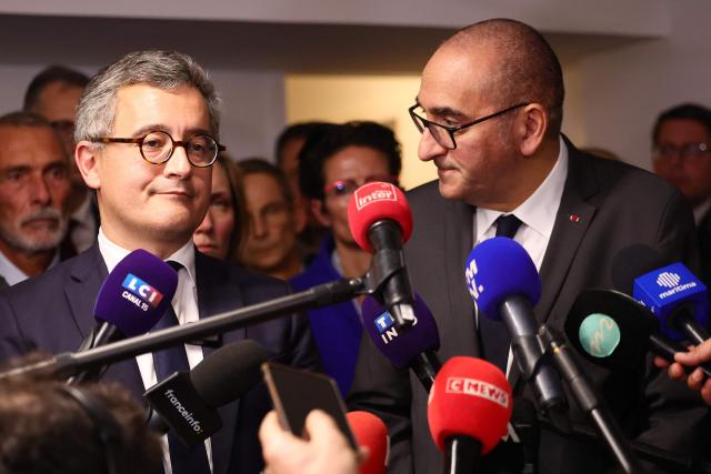 France's Interior Minister Laurent Nunez (C, R) and France's Justice Minister Gerald Darmanin answer journalists' questions during a visit following the killing last week in Marseille of the younger brother of anti-drug activist, in Marseille on November 20, 2025. The killing last week in Marseille of Mehdi Kessaci, the younger brother of anti-drug activist Amine Kessaci amplified concern over the soaring death toll of narcotics-driven crime. (Photo by Clement MAHOUDEAU / AFP)
