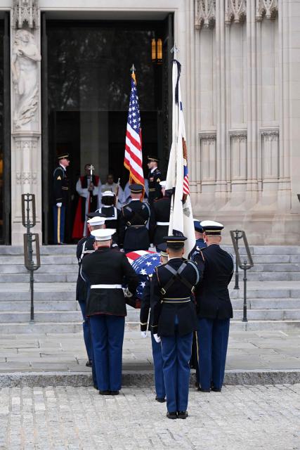 A team of US armed forces body bearers carry the casket of late US Vice-President Dick Cheney into the Washington National Cathedral for his funeral service in Washington, DC on November 20, 2025. (Photo by ROBERTO SCHMIDT / AFP)