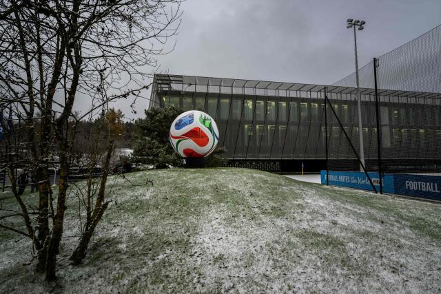 This photograph shows a giant replica of 'Trionda' the official ball of the 2026 FIFA World Cup outside of the FIFA's Home of Football during the 2026 FIFA World Cup European Play-Off draw in Zurich on November 20, 2025. (Photo by Fabrice COFFRINI / AFP)