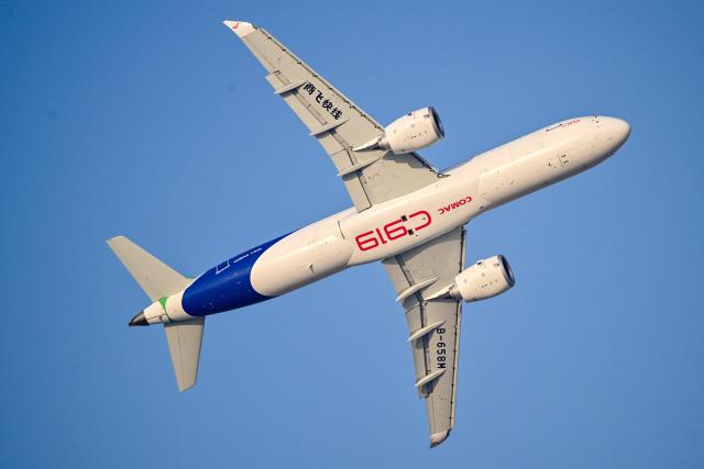 The Chinese Comac C919 performs a display flight at Al-Maktoum International Airport during the Dubai Airshow 2025 in Dubai on November 20, 2025. (Photo by Giuseppe CACACE / AFP)