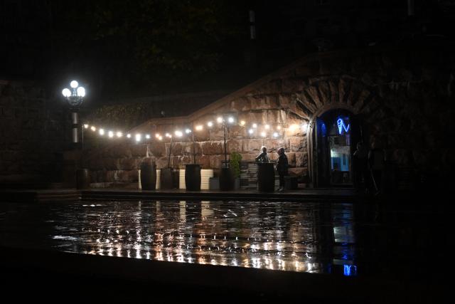 People visit a bar in Kyiv on November 20, 2025, amid the Russian invasion of Ukraine. (Photo by Sergei GAPON / AFP)