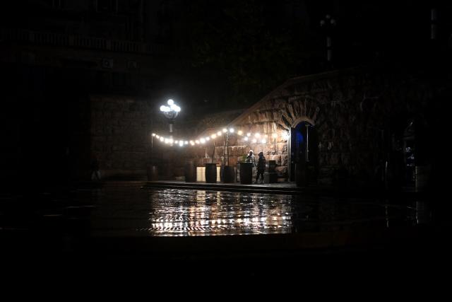 People visit a bar in Kyiv on November 20, 2025, amid the Russian invasion of Ukraine. (Photo by Sergei GAPON / AFP)