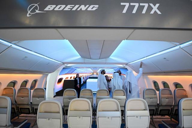 Visitors inspect the cabin of a Boeing 777-X displayed at Al-Maktoum International Airport during the Dubai Airshow 2025 in Dubai on November 20, 2025. (Photo by Giuseppe CACACE / AFP)