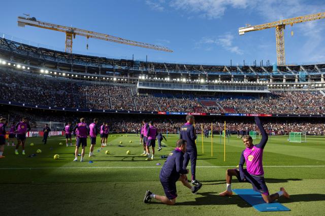 (FILES) Barcelona's Spanish forward Lamine Yamal (R) takes part in an open training session, the first at the new Camp Nou since the beginning of the construction works more than two years ago, on November 7, 2025 in Barcelona. After two and a half years, FC Barcelona will return on November 23, 2025 to the Camp Nou, its mythical stadium still under construction and whose renovation should embody the renewed ambitions of the Catalan giant. (Photo by Josep LAGO / AFP)