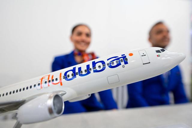 A FlyDubai 737 Max model is on display at Al-Maktoum International Airport during the Dubai Airshow 2025 in Dubai on November 20, 2025. (Photo by Giuseppe CACACE / AFP)