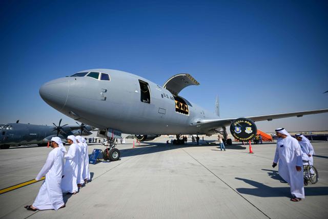 Visitors walk past a Boeing KC-46 Pegasus at Al-Maktoum International Airport during the Dubai Airshow 2025 in Dubai on November 20, 2025. (Photo by Giuseppe CACACE / AFP)