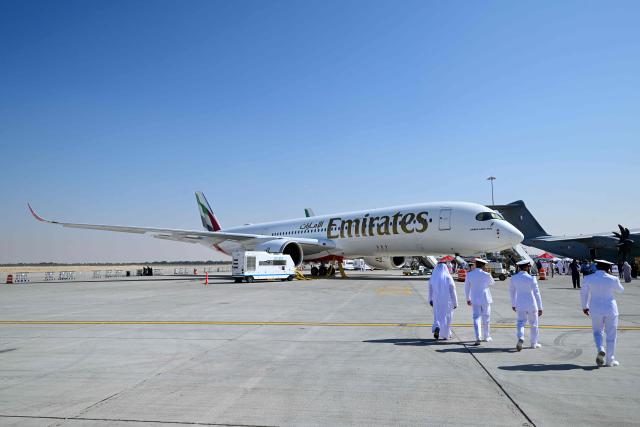 An Emirates Airbus A350-900 is displayed at Al-Maktoum International Airport during the Dubai Airshow 2025 in Dubai on November 20, 2025. (Photo by Giuseppe CACACE / AFP)